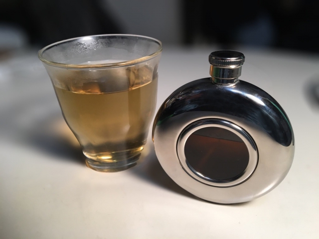 スキットルとグラスに入ったウイスキー