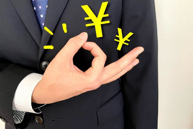 お金のジェスチャーをするスーツ姿の男性