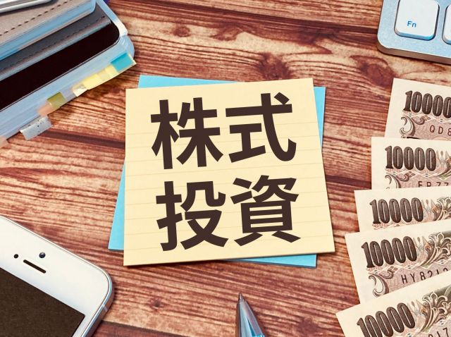 株式投資と書かれた紙と現金